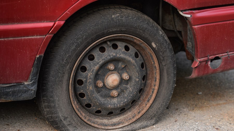 A flat tire on a red vehicle