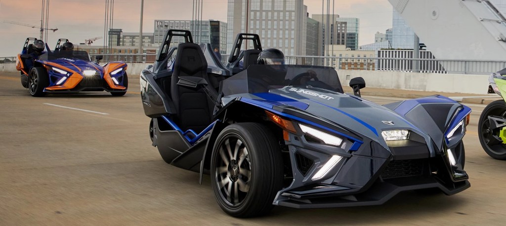 An image of a 2021 Polaris Slingshot driving down the road.