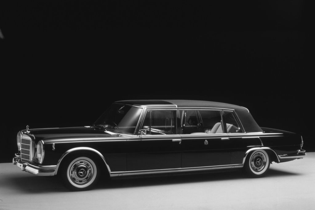 A black 1965 Mercedes 600 Pullman Landaulet parked in a studio