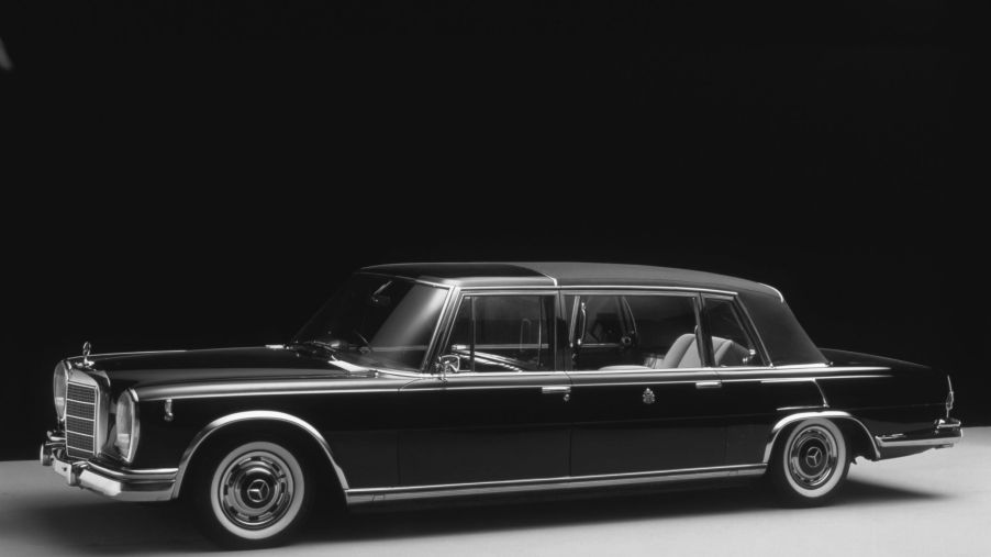 A black 1965 Mercedes 600 Pullman Landaulet parked in a studio