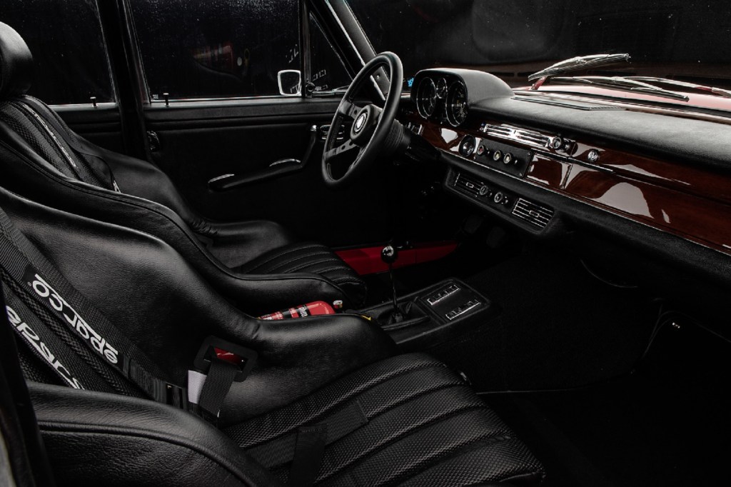 The black-leather front bucket seats and real-wood-trim of a 1971 Mercedes 300 SEL 6.8 AMG 'Red Pig' replica