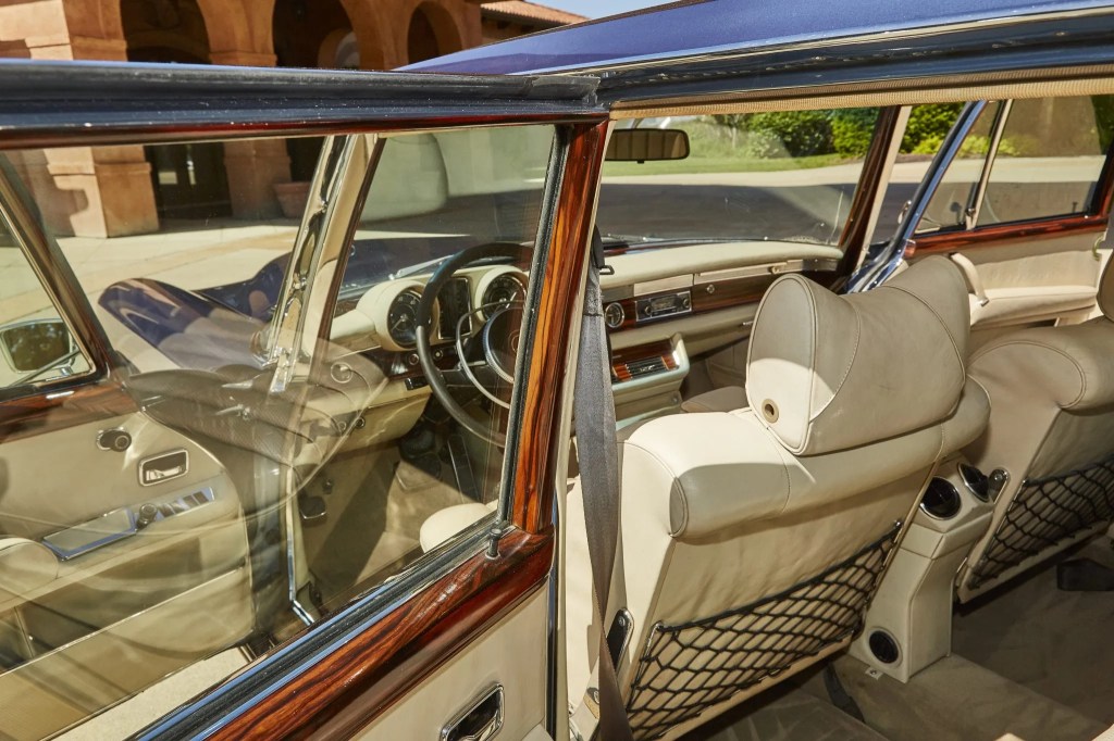 The white-leather and brown-wood-trimmed interior of a blue 1971 Mercedes 600