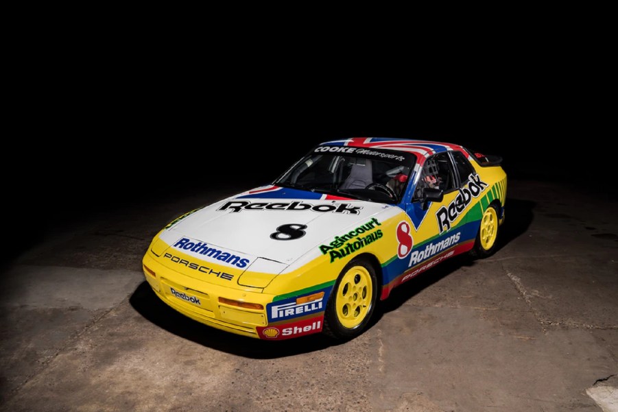 A multi-colored Rothmans-liveried 1988 Porsche 911 Turbo Cup in a warehouse
