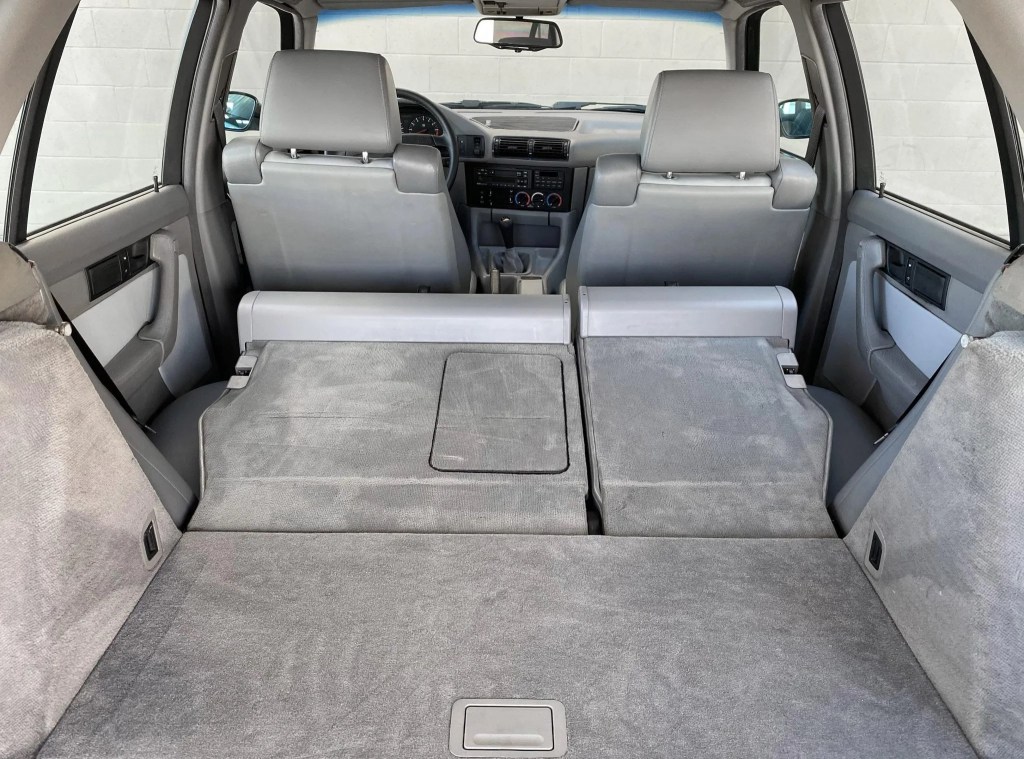 The rear view of the gray-leather interior of a 1992 BMW M5 Touring with its rear seats folded