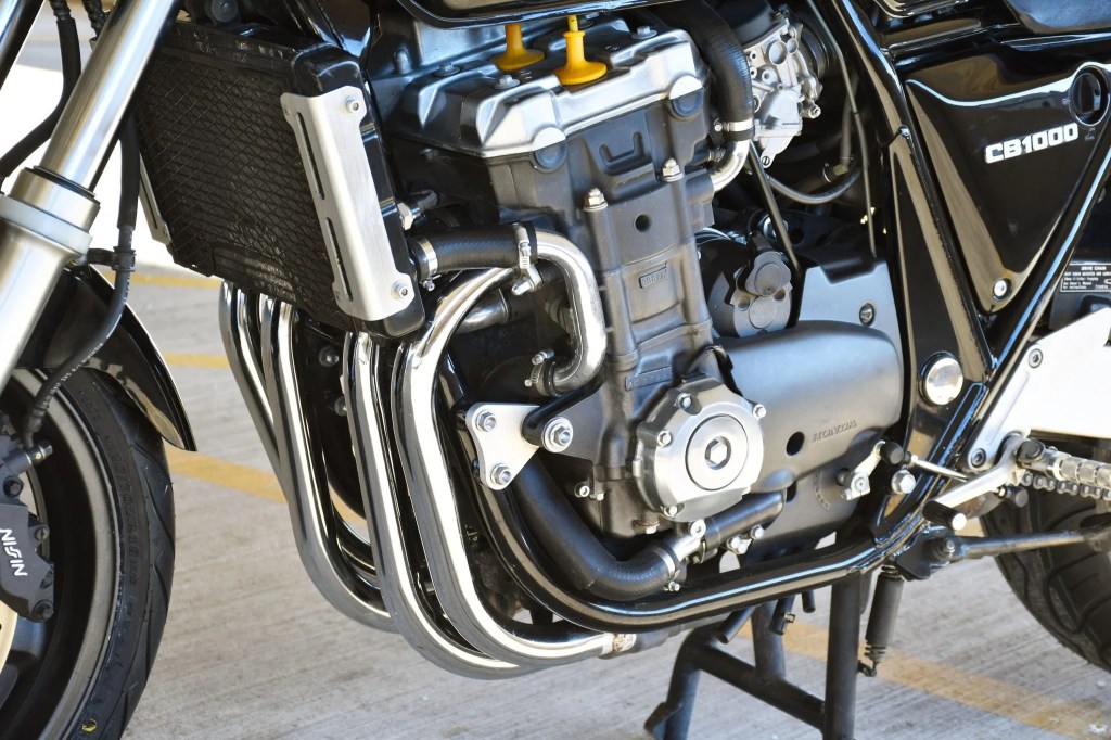 A close view of a black 1994 Honda CB1000 Super Four's liquid-cooled 998cc inline-four engine