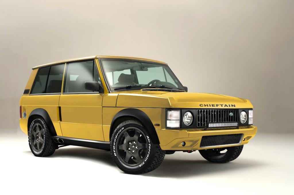 An image of a yellow Range Rover Chieftain by Jensen International Automotive inside of a studio.