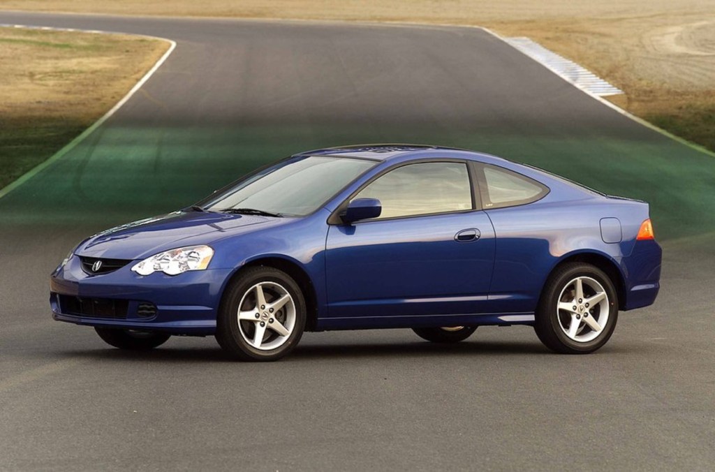 A blue 2002 Acura RSX Type S parked on a racetrack