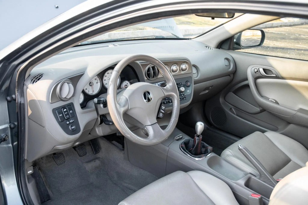 The gray-leather-upholstered front seats and dashboard of a 2005 Acura RSX Type S