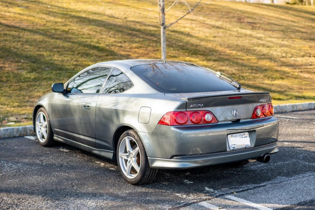 The side 3/4 view of a gray 2005 Acura RSX Type S in a sunny parking lot
