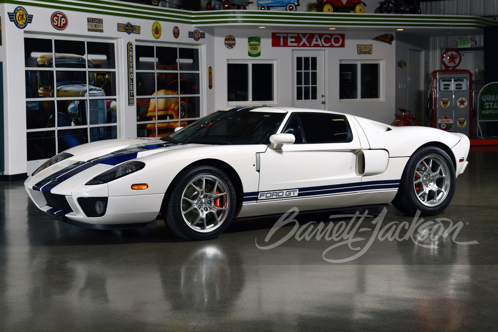 A white 2006 Ford GT with blue racing stripes