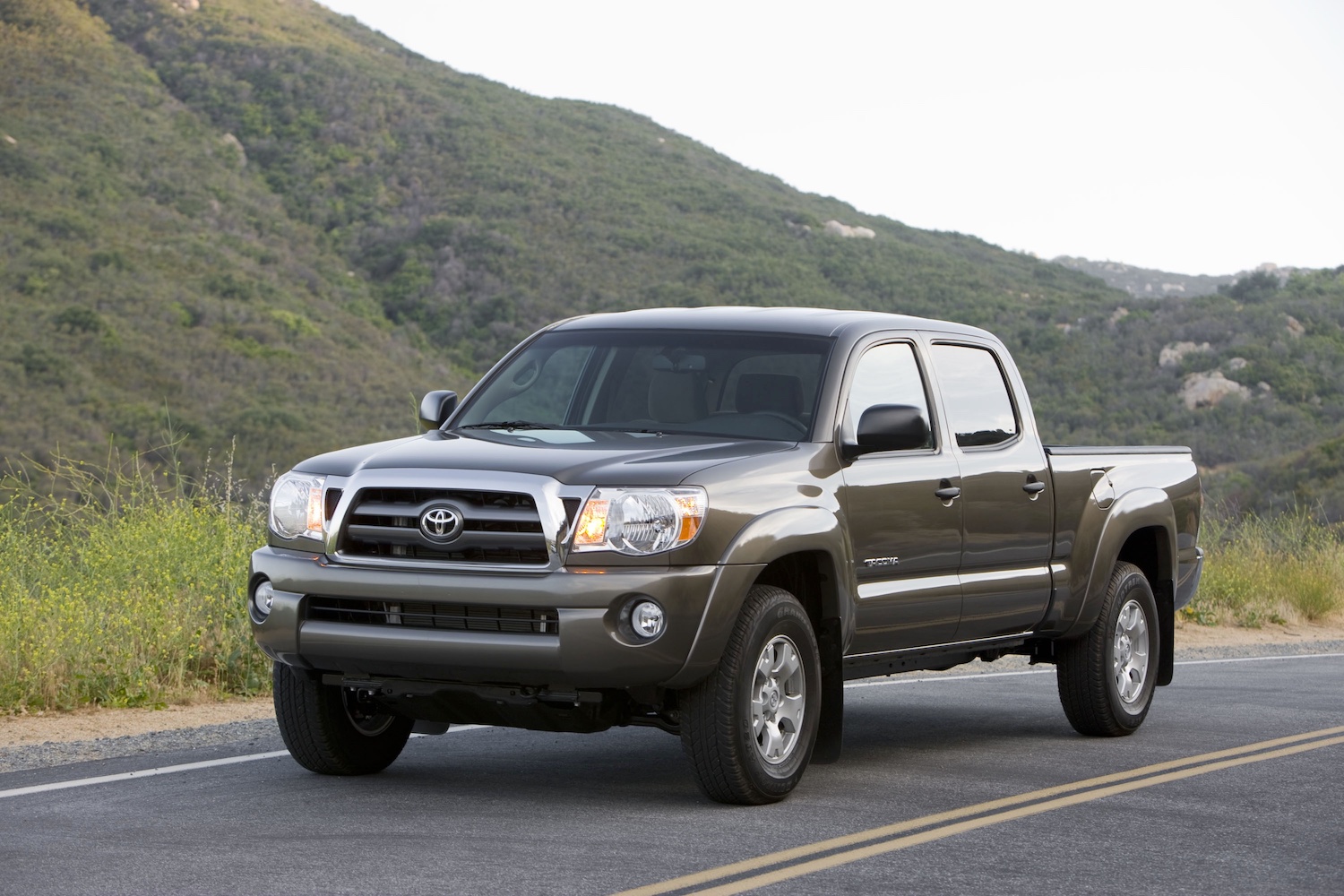 a 2009 model from the second Toyota Tacoma generation driving on a mountain road. 