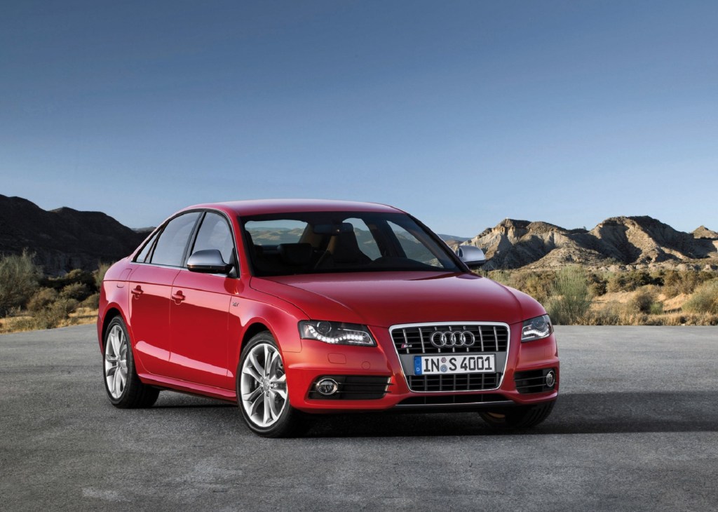 A red 2010 B8 Audi S4 parked on a mountainside parking lot