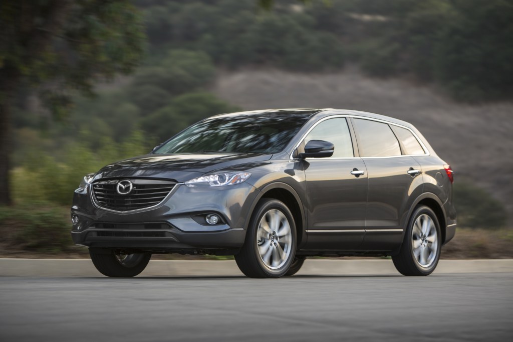A grey 2013 Mazda CX-9 driving down the road