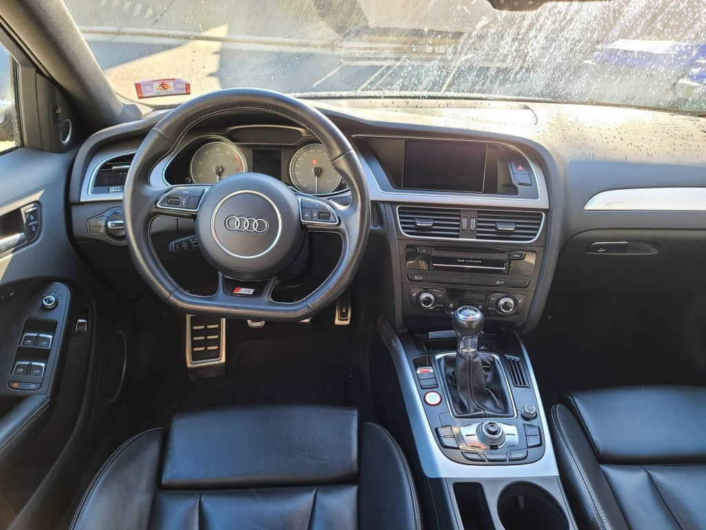 The black-leather front seats and dashboard of a 2014 Audi S4