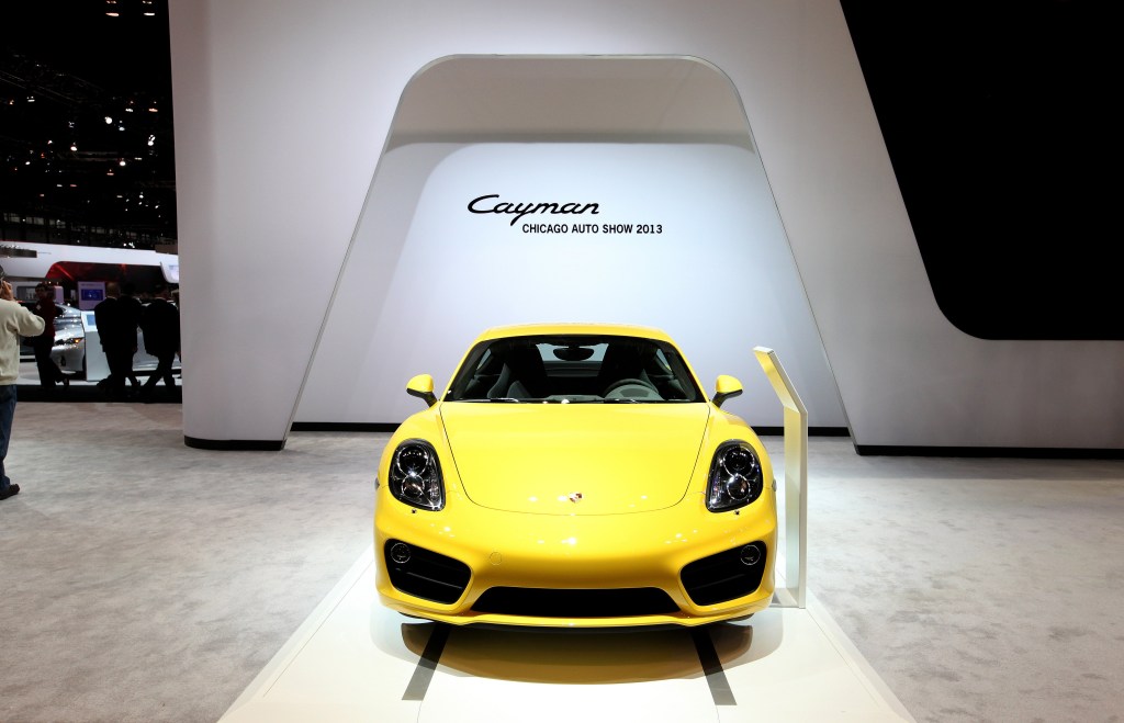 A yellow 2014 Porsche Cayman S coupe on display