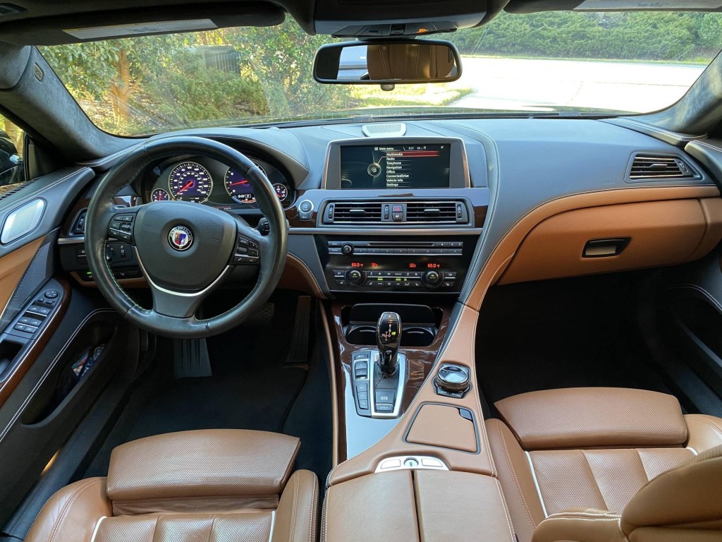 The brown-leather front seats and black dashboard of a 2015 BMW Alpina B6 xDrive Gran Coupe