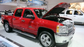 A red Chevrolet Silverado 1500 sits on display at an auto show