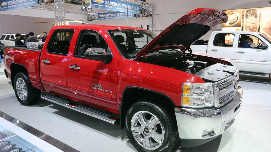 A red Chevrolet Silverado 1500 sits on display at an auto show