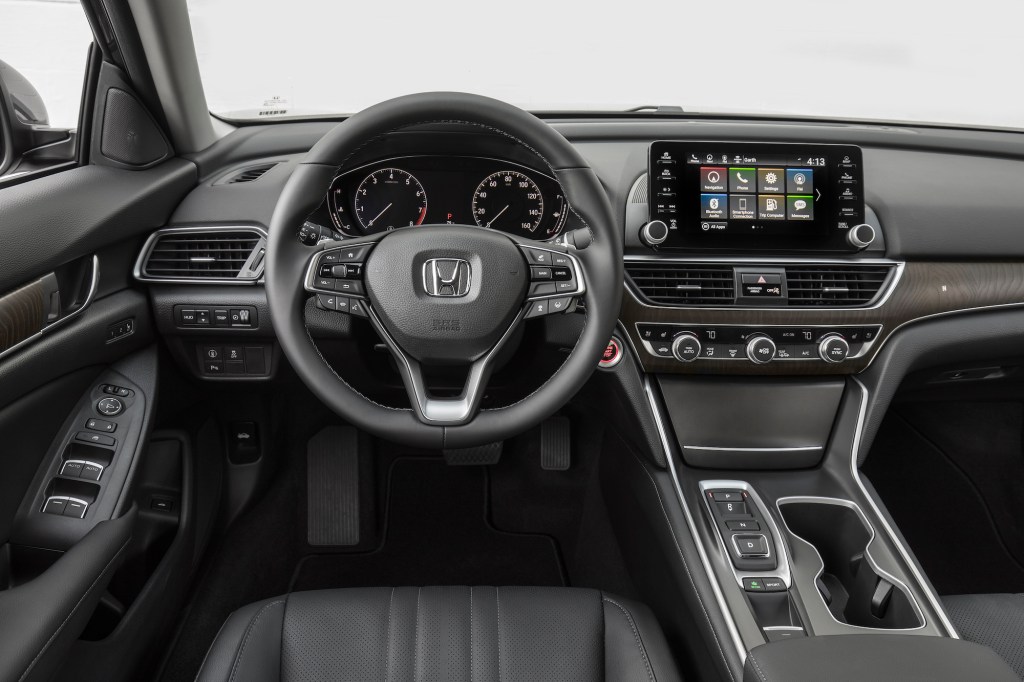 The black cockpit, including the steering wheel, of a 2018 Honda Accord Touring 2.0T sedan