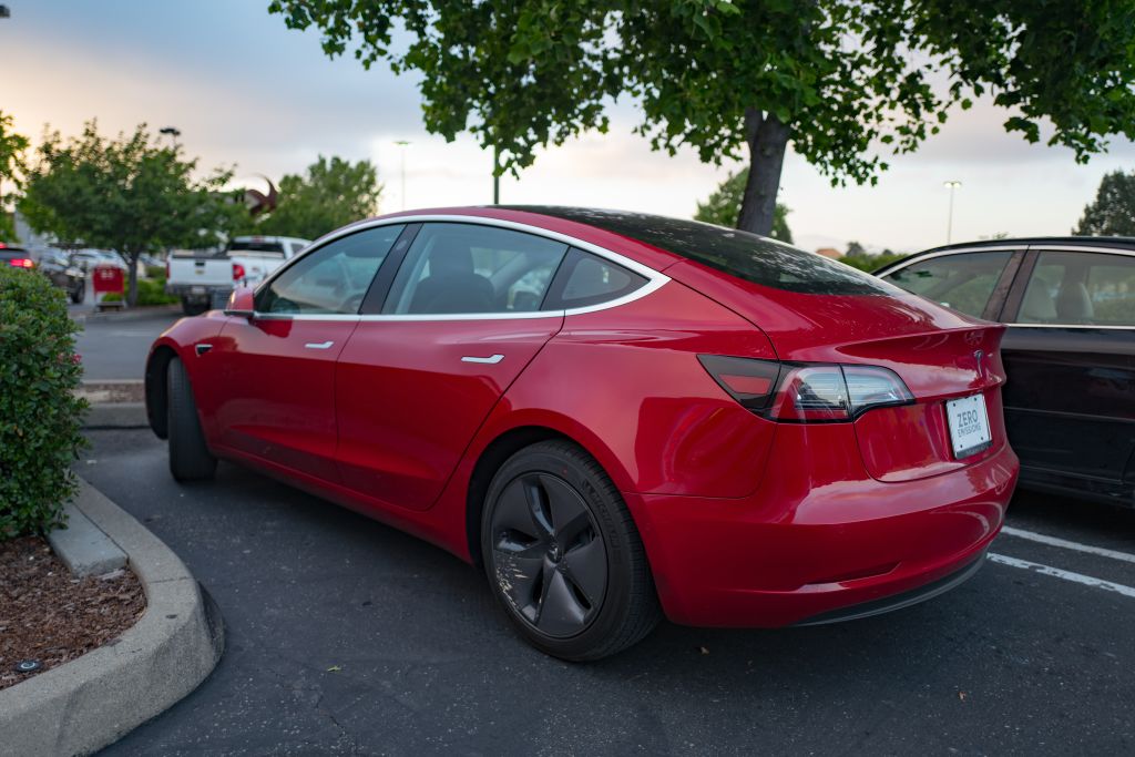 Side view of a red Tesla model 3