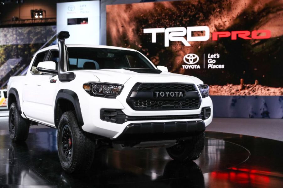 A white 2018 Toyota Tacoma Pickup truck on display