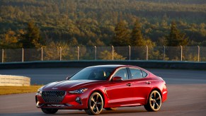 A red 2019 Genesis G70 sports sedan parked on the road course at Club Motorsports in Tamworth, New Hampshire, in July 2019