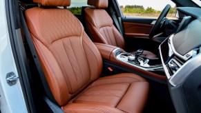 The quilted tan-leather front seats of a 2020 BMW X7 crossover SUV