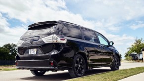 A black 2020 Toyota Sienna Nightshade minivan parked along a curb in a residential neighborhood