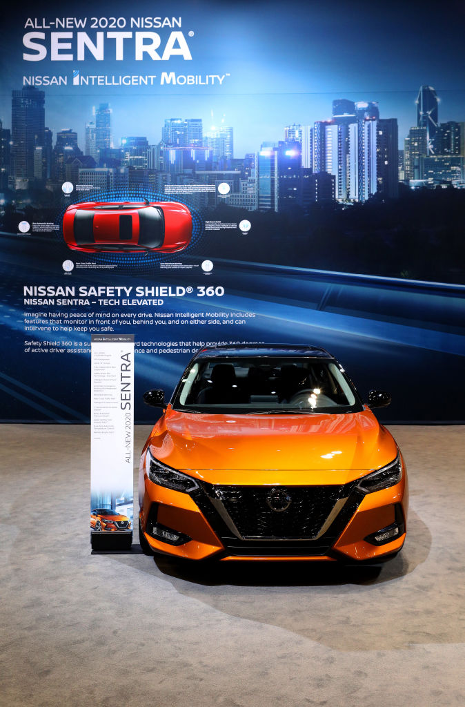 An orange 2020 Nissan Sentra on display pictures from the front