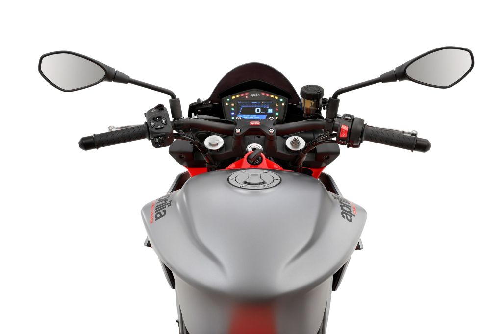 The handlebar and TFT display of a silver-and-red 2021 Aprilia Tuono 660