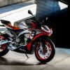 A silver-and-red 2021 Aprilia Tuono 660 by a concrete ramp