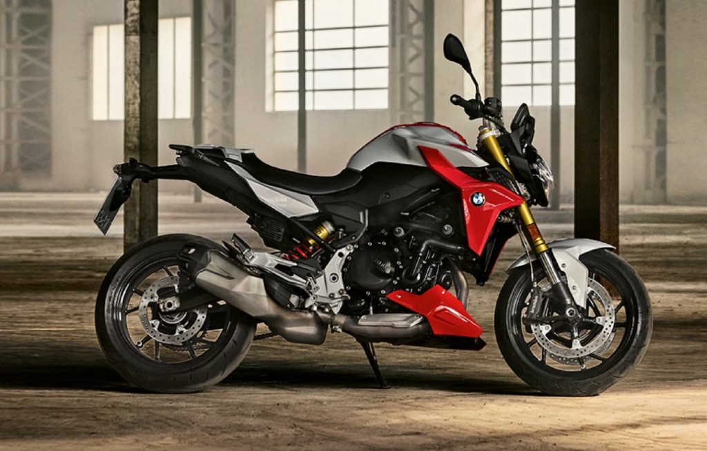 The side view of a red-and-silver 2021 BMW F 900 R in a warehouse