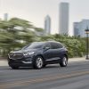 A dark blue 2021 Buick Enclave luxurious midsize SUV driving down a highway road