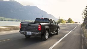 A black 2021 Chevy Colorado Diesel LT driving down a highway road