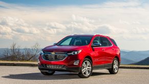 A 2021 Chevy Equinox parked on pavement with a cloudy sky in the background
