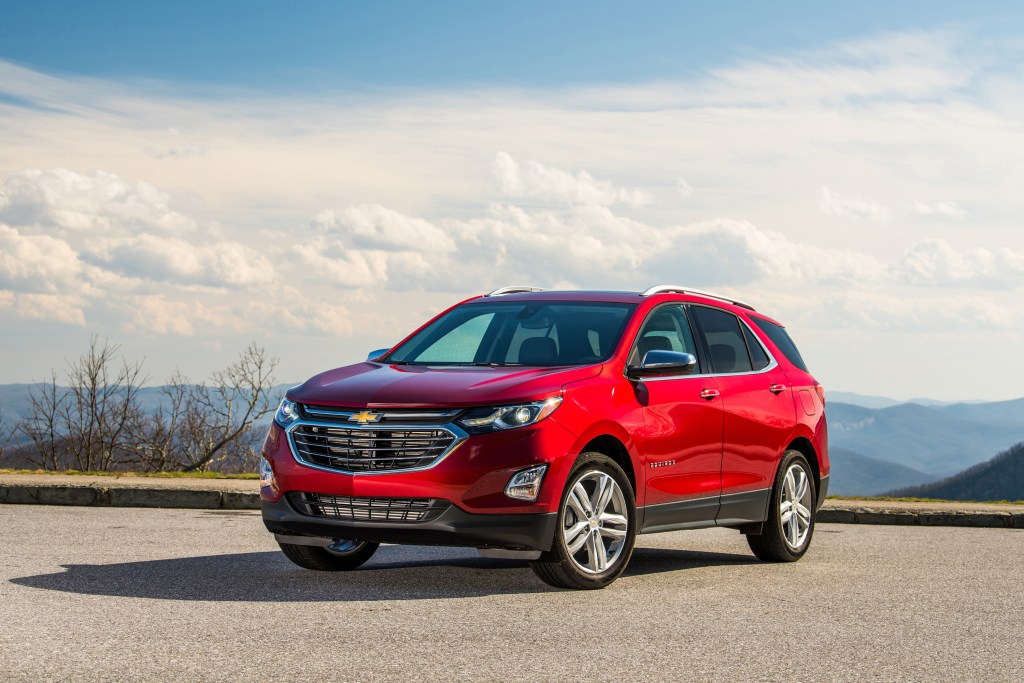 A 2021 Chevy Equinox parked on pavement with a cloudy sky in the background