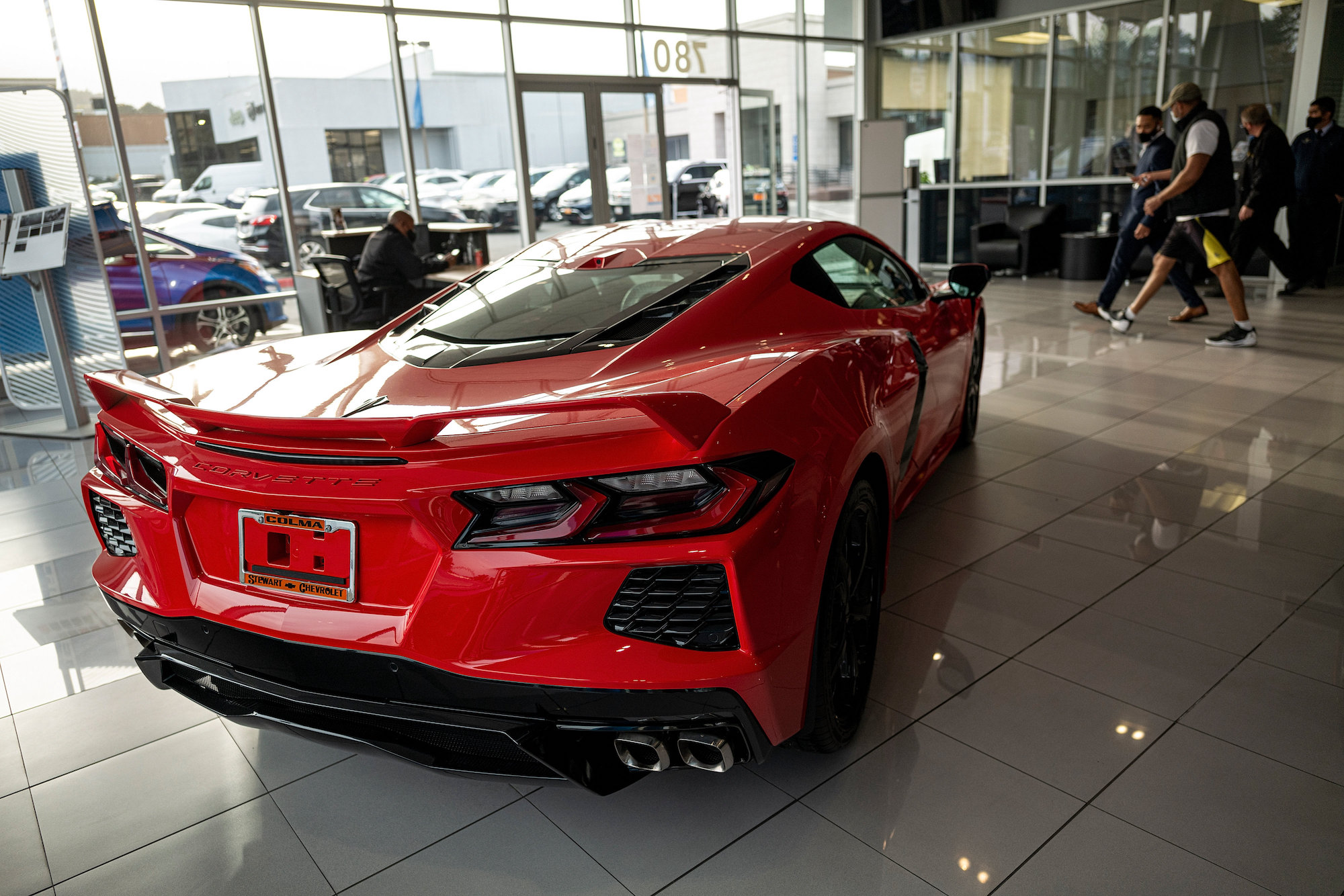 A red 2021 Chevy Corvette sports car parked inside a car dealership in Colma, California, on Monday, February 8, 2021
