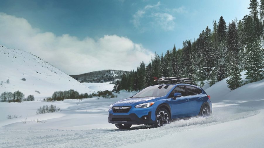2021 Subaru Crosstrek in blue riding through the snow
