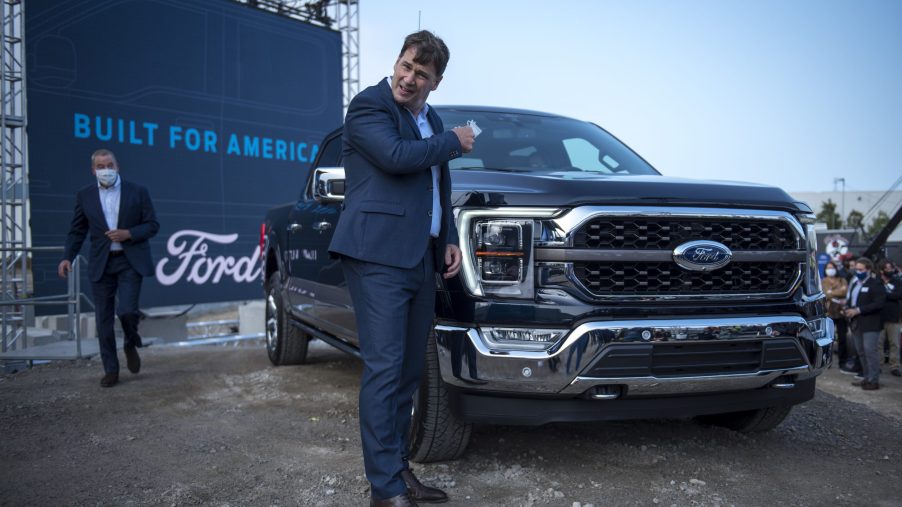 Ford CEO Jim Farley takes off his mask at the Ford Built for America event at Ford’s Dearborn Truck Plant
