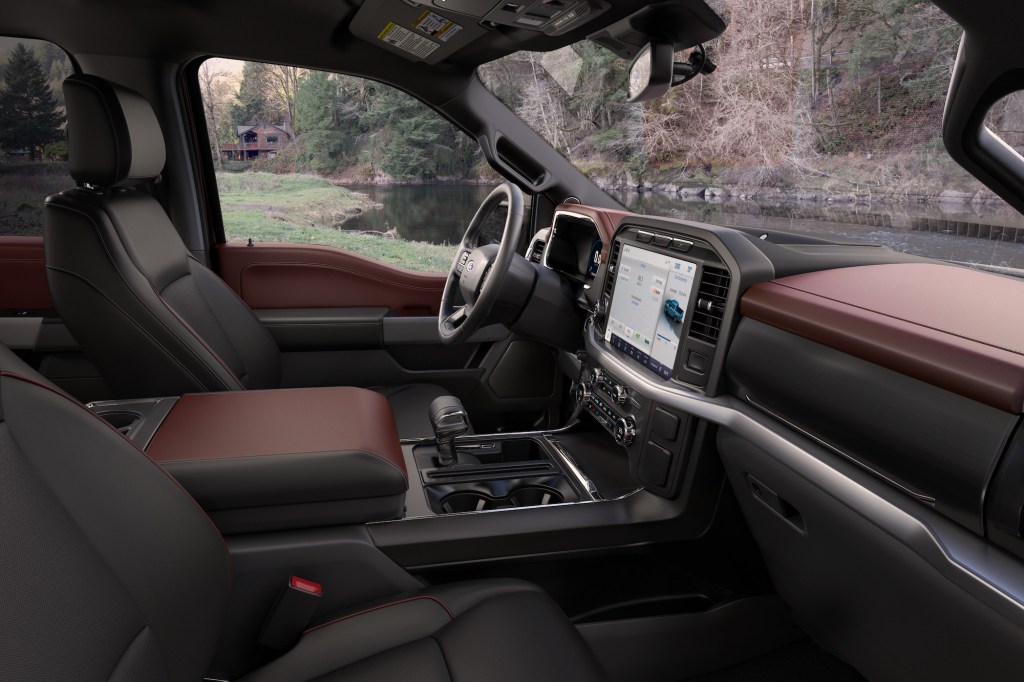 A 2021 Ford F-150 Lariat Sport pickup truck's black-and-maroon interior