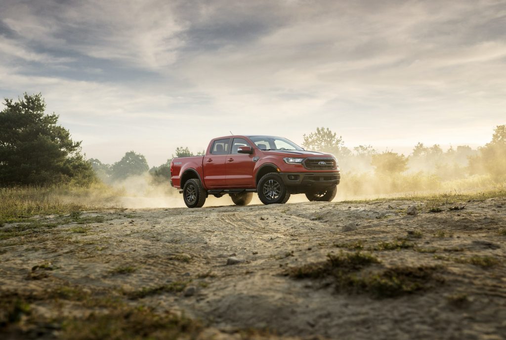 A red 2021 Ford Ranger Tremor Lariat parked on a dusty hill