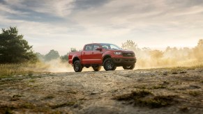 A red 2021 Ford Ranger Tremor Lariat parked on a dusty hill