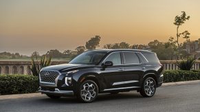 2021 Hyundai Palisade Calligraphy parked on display with a dusk sky in the background
