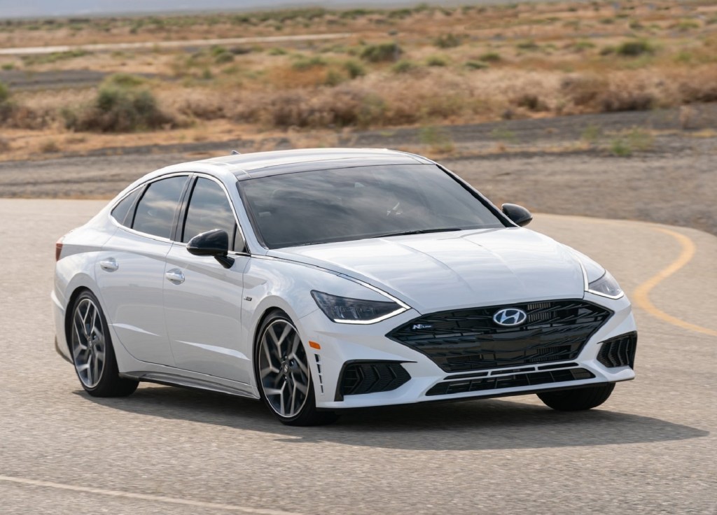 A white 2021 Hyundai Sonata N Line takes a corner on a desert road