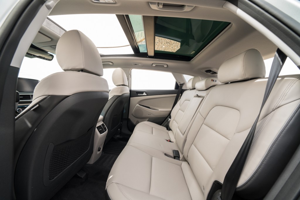 A view of the 2021 Hyundai Tucson compact crossover SUV's white-leather seating and panoramic sunroof