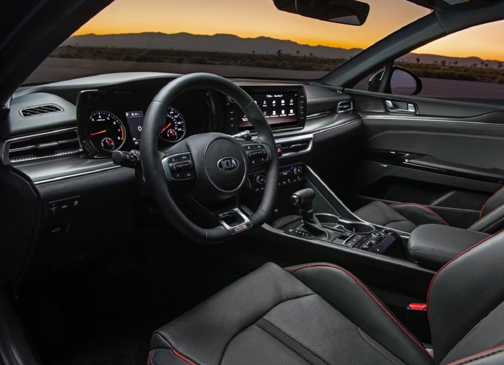 The red-trimmed black front seats and dashboard of the 2021 Kia K5 GT