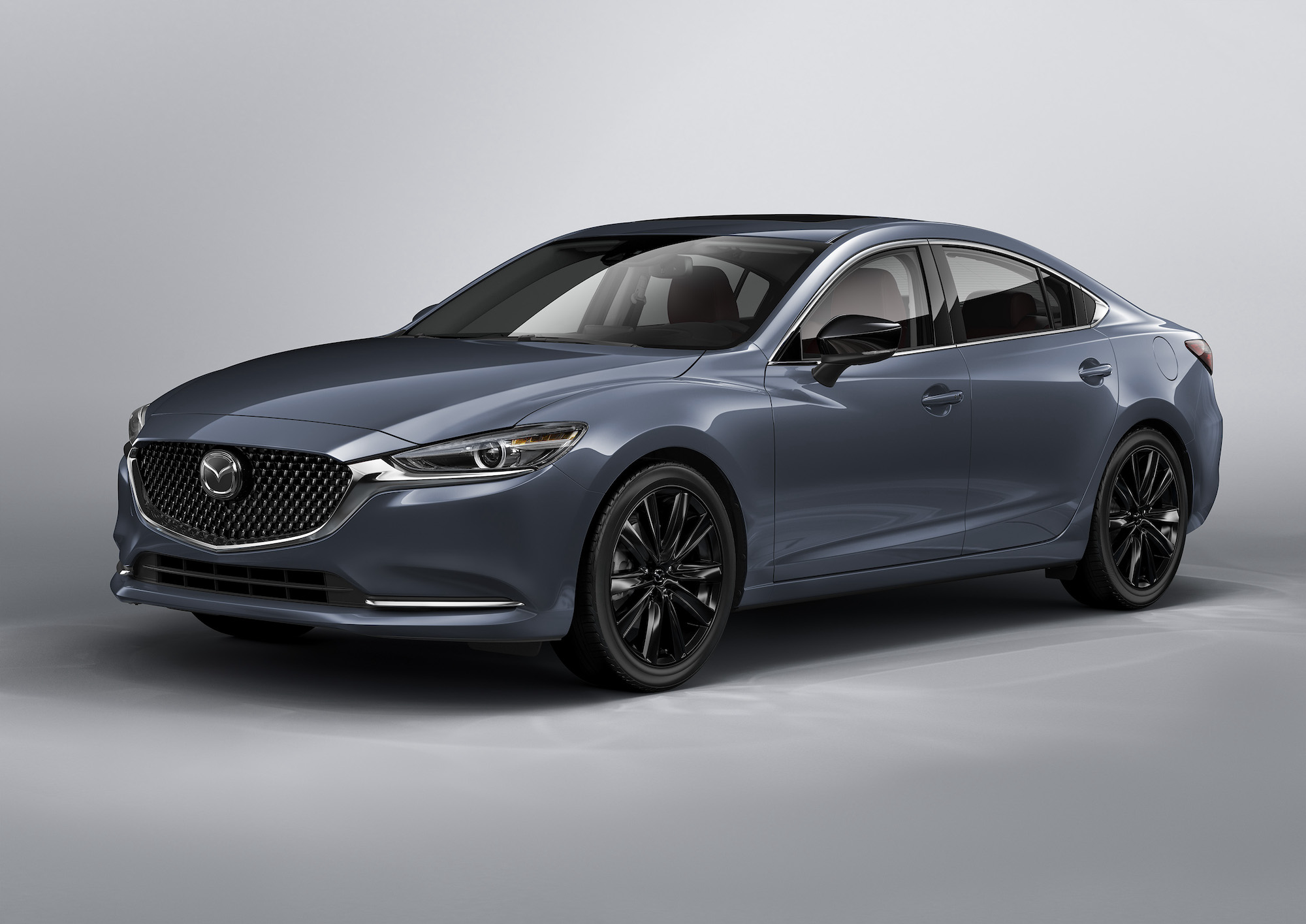 A 2021 Mazda6 Carbon Edition midsize sedan with black wheels, a black grille, and gray metallic body paint