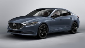 A 2021 Mazda6 Carbon Edition midsize sedan with black wheels, a black grille, and gray metallic body paint