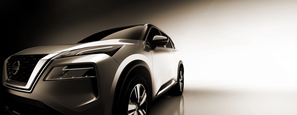 A silver 2021 Nissan Rogue against a neutral background