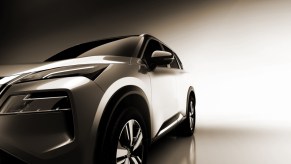 A silver 2021 Nissan Rogue against a neutral background